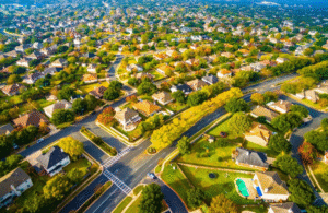 Modern Layout Suburban Neighborhood outside Austin Texas Aerial View. Above Autumn Colors Aerial on Suburbs Homes in Austin , Texas. Looking down Birds Eye View on Suburbia Homes in Austin , Texas a Colorful Residential Area in Fall Autumn.