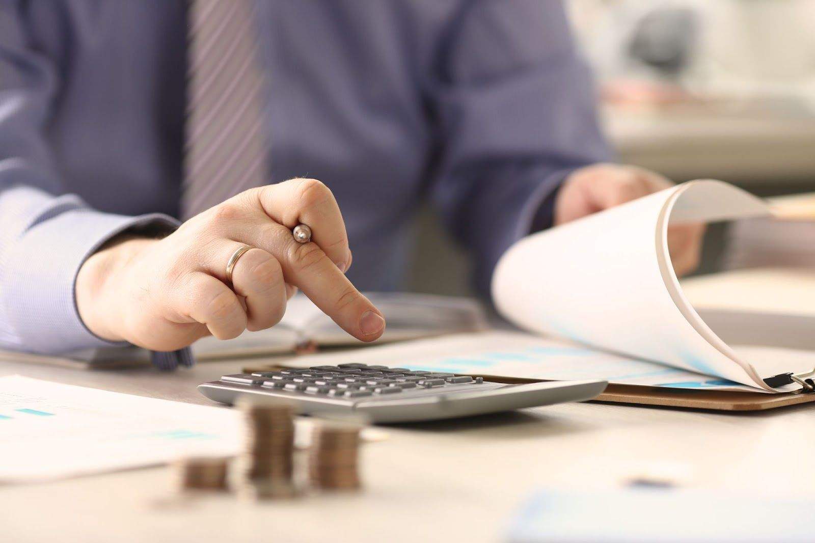 Investor calculating real estate tax benefits with bonus depreciation, property improvement deductions, and capital gains planning.