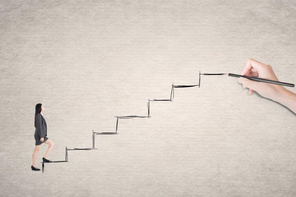 Businesswoman climbing drawn staircase symbolizing strategic action steps for investors to maximize OBBB tax advantages, financing, and real estate portfolio growth in Texas.