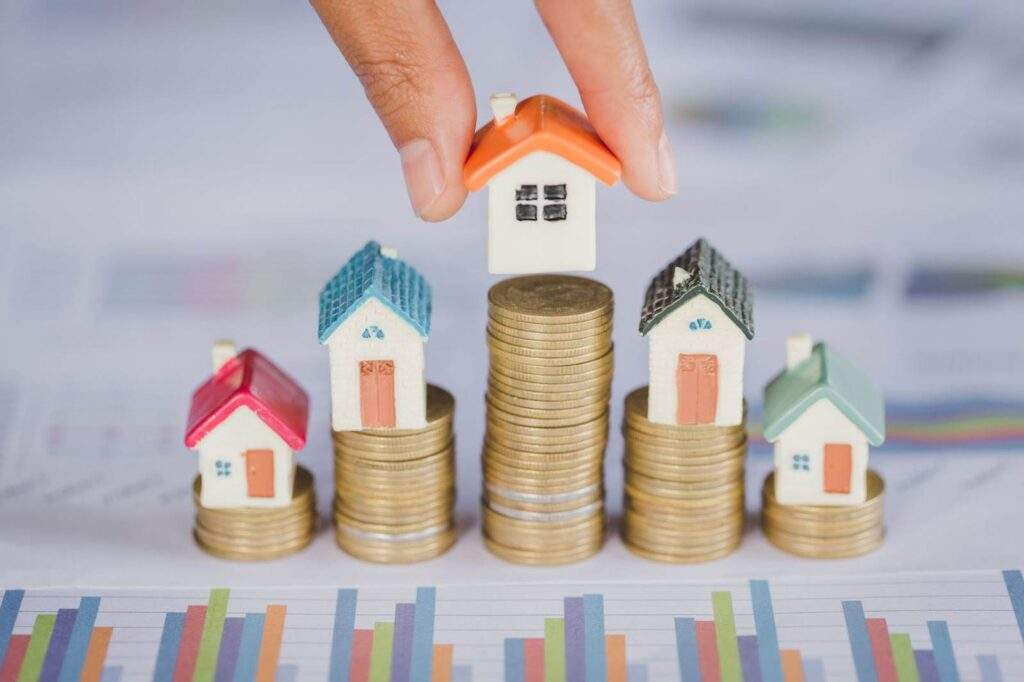 Stacked coins with miniature houses representing real estate portfolio growth and cash flow benefits from OBBB tax, financing, and regulatory updates in Texas.