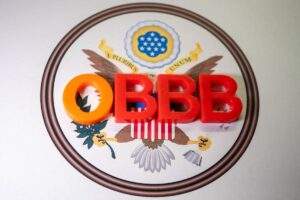 A clipboard with the words 'ONE BIG BEAUTIFUL BILL' on a U.S. flag, symbolizing new policy changes.