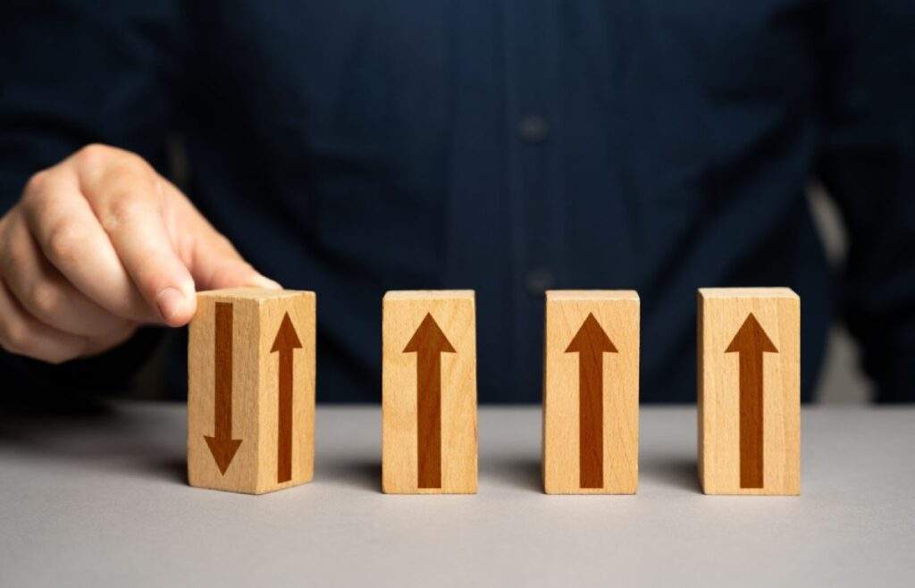Wooden blocks with upward arrows symbolizing regulatory updates and growth opportunities for Texas real estate investors under OBBB."