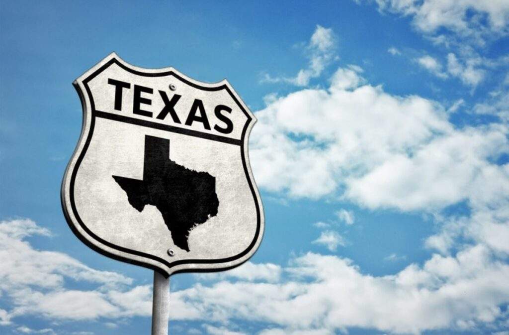Texas road sign with state silhouette representing OBBB’s impact on real estate markets across Houston, Austin, Dallas, San Antonio, and Corpus Christi.