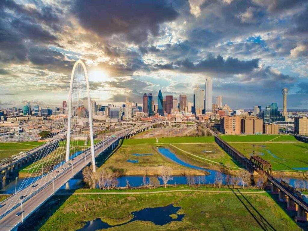 Dallas skyline and Margaret Hunt Hill Bridge representing Texas real estate growth and land donation tax incentive benefits