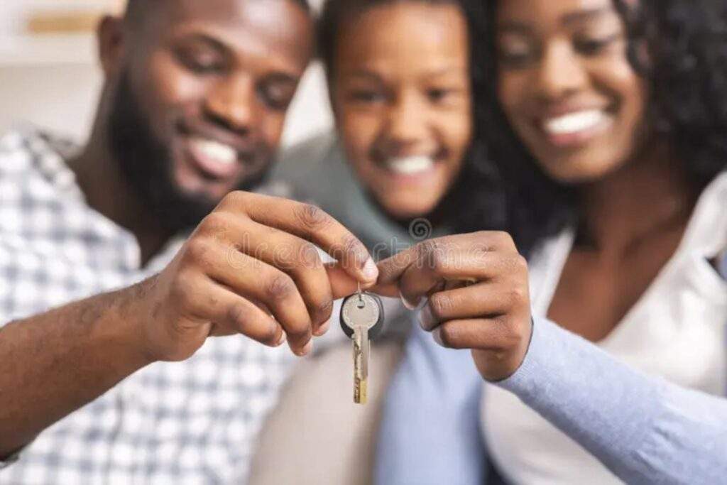 Homebuyers celebrating mortgage approval after AI credit scoring evaluation for real estate financing